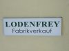 Weier Leuchtkasten mit grn schwarzer Schrift von Lodenfrey in Mnchen